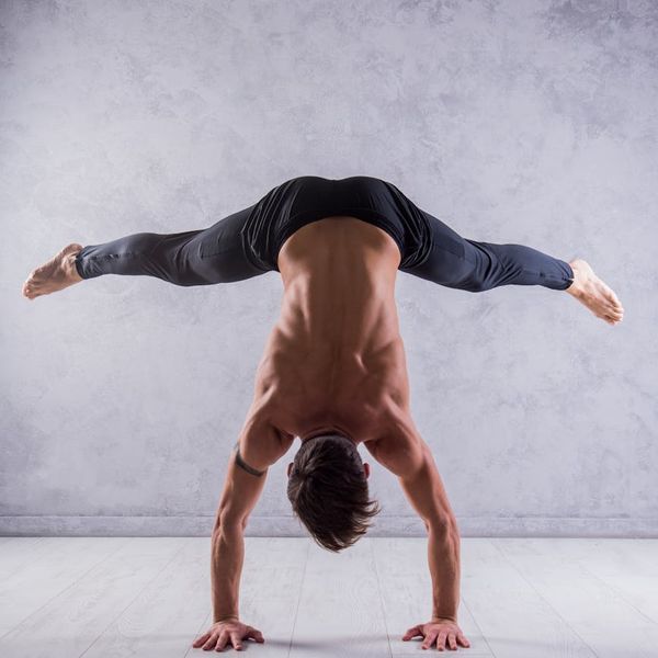 Athlete holding a difficult balance pose, showing core strength and stability.